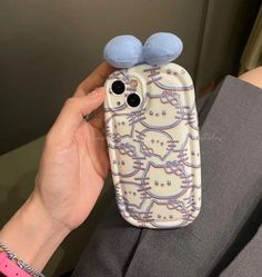 a person holding up a cell phone case with two blue birds on it