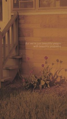 the flowers are blooming in front of the door and steps to an outside porch