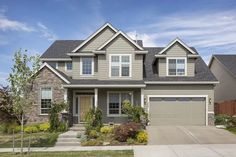 a large house with two garages in the front yard