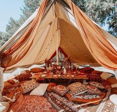 a large tent with many pillows on the ground