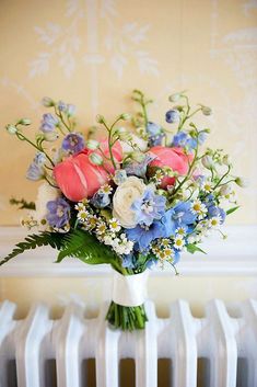 a bouquet of flowers sitting on top of a radiator