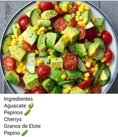 a bowl filled with cucumber, tomatoes and avocado