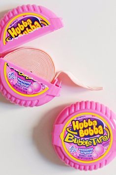 two pink gummy bubble tape holders on a white surface