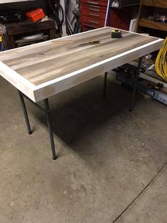 a table that is in the middle of some workbench with tools on it