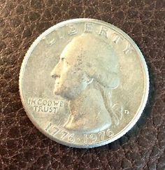 an image of a coin that is on a brown leather surface with the word, lincoln trust