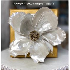 a close up of a white flower on a cake