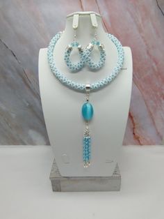 "Hand crafted by me-one of a kind necklace set-spiral bead crochet memory wire choker necklace with sky blue and white seed beads-has a 6\" focal with a cat's eye pendant and a chain tassel-can be worn without the focal-glass crystal beads-metal beads-2 1/2\" long matching hoop earrings with an ear wires-silver tone findings. This unique necklace set would be a beautiful addition to your jewelry wardrobe!" Light Blue Beaded Dangle Jewelry, Handmade Turquoise Spiral Jewelry, Handmade Spiral Turquoise Jewelry, Handmade Light Blue Dangle Jewelry, Wire Choker Necklace, Choker Necklace Set, Spiral Earrings, Wire Necklace, Memory Wire