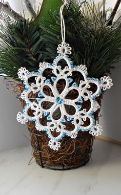 a snowflake ornament hanging from a wire basket