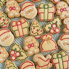 many decorated christmas cookies on a table