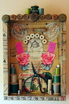 a clock made out of old sewing threads and spools with pink roses on it