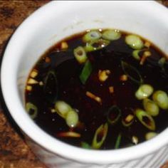 a white bowl filled with soup sitting on top of a counter