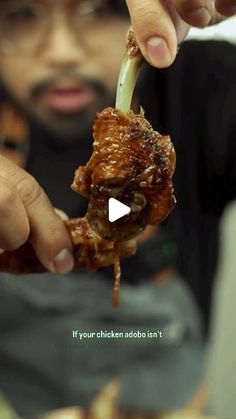 a man is eating food from a plate with chopsticks in his hand and the caption reads, if your chicken adob isn't