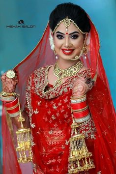 a woman dressed in red and gold is posing for the camera