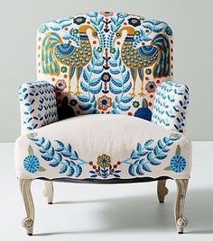 an ornately decorated chair with blue and orange accents