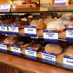 a display case filled with lots of different types of donuts