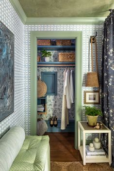 a bedroom with blue and white wallpaper, green walls and wooden flooring