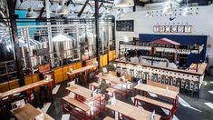 the inside of a restaurant with tables and benches