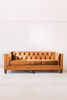 two brown couches sitting next to each other