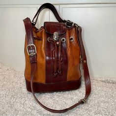 Marino Orlandi Vintage Two toned Brown Leather Bucket Bag Purse  Great pre loved vintage condition  Beautiful, unique purse  Tags: vintage, classic, leather, neutral, fall, everyday, unique  Marino Orlandi Vintage Two toned Brown Leather Bucket Bag Purse Unique Purses, Leather Bucket, Leather Bucket Bag, Gorgeous Bags, Jacket Buttons, Cross Body Handbags, Bucket Bag, Brown Leather, Christmas Sweaters