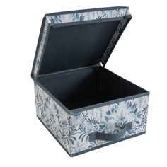 an open box with blue and white flowers on the inside is sitting in front of a white background