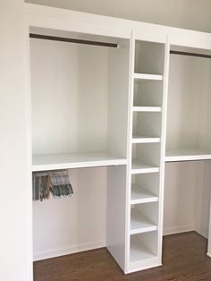 an empty closet with white shelves and drawers