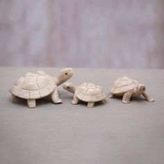 three small turtle figurines sitting next to each other