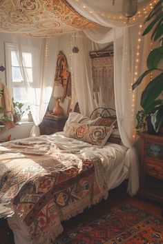 a bed sitting in a bedroom next to a window covered in white curtains and lights