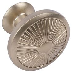 an antique brass door knob with a sunburst design