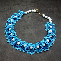 Add a touch of bohemian elegance to your ensemble with our handmade beaded lace necklace. Crafted with care, this stunning piece features intricate blue beadwork and accents of white agate beads. Finished with 18k gold-filled charms for a touch of luxury, it's a unique addition to any jewelry collection. Perfect for adding a pop of color to your outfit, this necklace is sure to turn heads wherever you go. Complete with a secure clasp and extender chain for the perfect fit, it's the quintessentia Bohemian Wedding Beads, Blue Bohemian Beaded Necklaces With Bead Caps, Blue Bohemian Beaded Necklaces, Blue Bohemian Necklaces With Bead Caps, Elegant Bead Cap Necklaces For Festivals, Elegant Festival Necklace With Bead Caps, Elegant Necklace With Bead Caps For Festivals, Bohemian Necklaces With Bead Caps And Round Beads, Bohemian Necklaces With Bead Caps