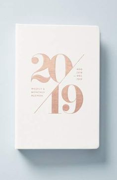 a white book with the number twenty nine on it's cover, and gold foil lettering