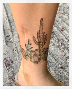 a woman's foot with a cactus tattoo on it