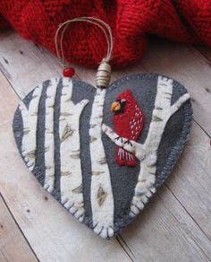 a heart shaped ornament with a bird on it