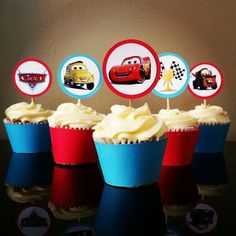 cupcakes with cars on them sitting on a table