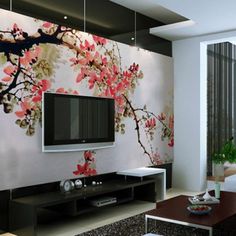 the living room is decorated in white and black with pink flowers on the tv stand