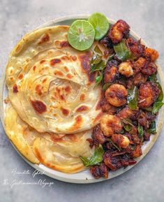 some food is sitting on a plate and ready to be eaten with lime wedges