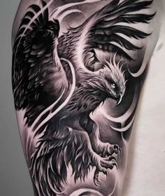 an eagle and bird tattoo on the back of a man's left upper arm