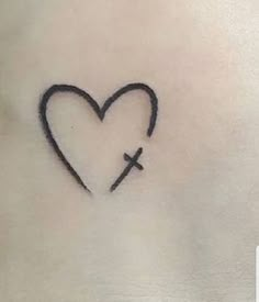 a heart with a cross tattoo on it