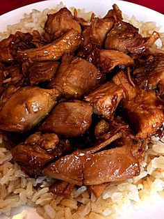 a white plate topped with rice and meat