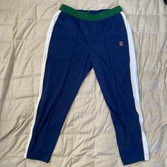 Nike Tennis Pants Brand New Regular Fit Nike Blue Athleisure Pants, Nike Blue Relaxed Fit Sweatpants, Nike Tapered Leg Pants With Elastic Waistband, Nike Sporty Navy Pants, Blue Nike Bottoms With Pockets, Blue Sporty Tapered Leg Bottoms, Sporty Blue Tapered Leg Bottoms, Nike Tapered Leg Athleisure Bottoms, Nike Athleisure Tapered Leg Bottoms