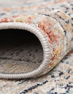 a close up view of a carpet with an area rug on the floor that looks like it has been made out of wool