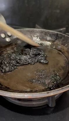 someone is stirring something in a pan on the stove