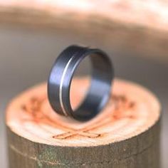 a couple of rings sitting on top of a piece of wood