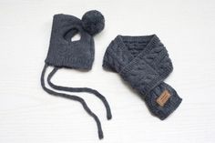 two knitted hats and mittens on a white surface