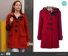 the young woman is wearing a red duffle coat