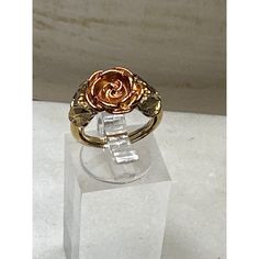 This vintage ring showcases an exquisite and intricately designed rose enveloped by gracefully curling leaves, all cast in a mesmerizing burnished orange-rose hue. The delicate petals of the rose appear to unfurl with a timeless elegance, their rich color exuding a warm and captivating aura. Size: 5 Condition: New With Box Excellent Condition. Never Worn. Roses Ring, Avon Jewelry, Orange Roses, Vintage Avon, Vintage Ring, The Rose, Rings Statement, Rich Color, Vintage Rings