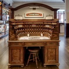 an old fashioned pharmacy cabinet with many bottles on the top and bottom shelf, in a museum