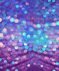 an abstract background with blue and purple circles in the center, as well as blurry lights