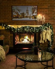 a living room decorated for christmas with stockings on the fire place and stockings hanging over the fireplace