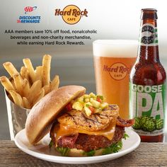 a plate with a burger and fries next to a beer