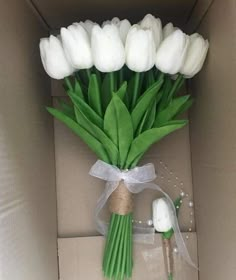 a bouquet of white tulips in a box